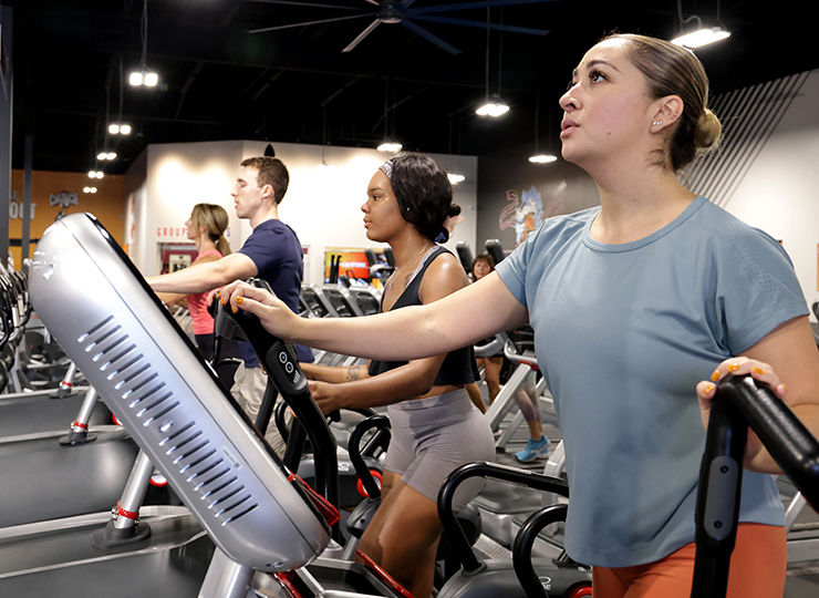 gym-goer working out on elliptical