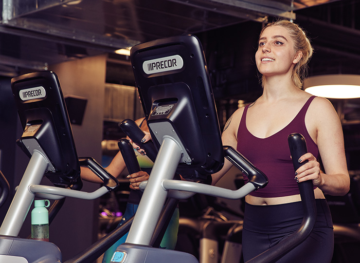 gym-goer working out on elliptical