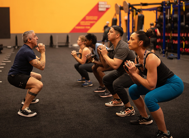 gym-goer squatting with weights