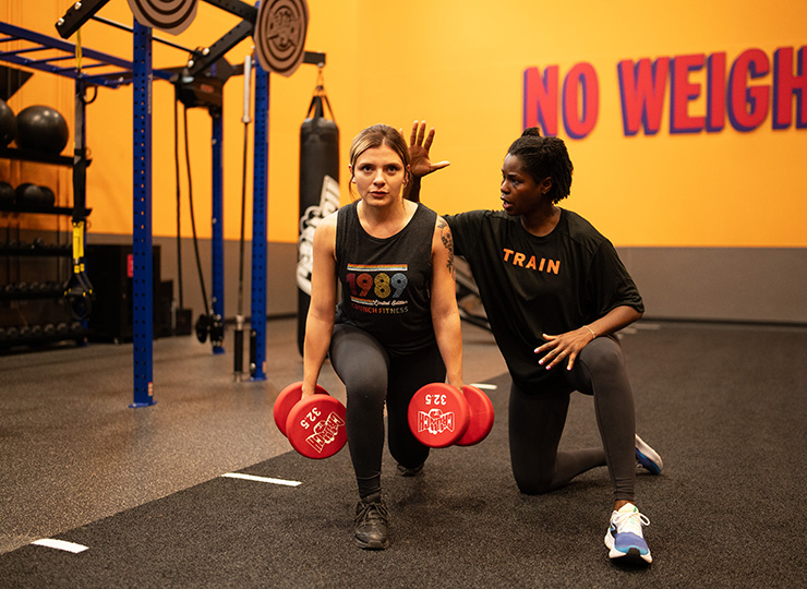 gym-goer working out with trainer