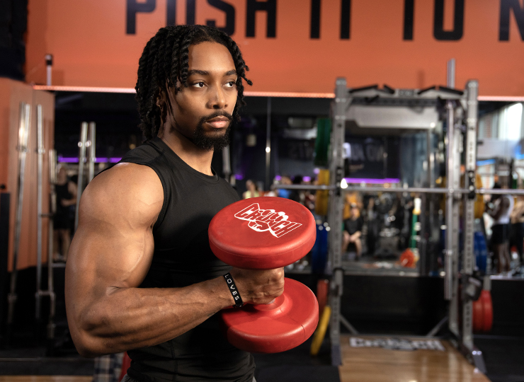 Man doing a dumbbell curl in the gym.