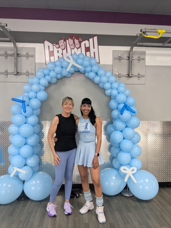 Gym-Goers at Augie's Quest event, standing in front of balloon arch