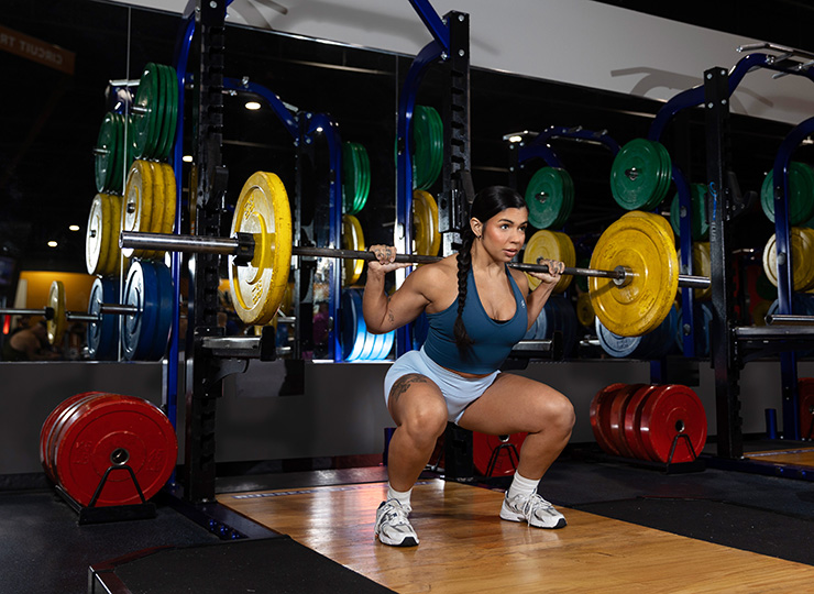 gym-goer barbell back squating