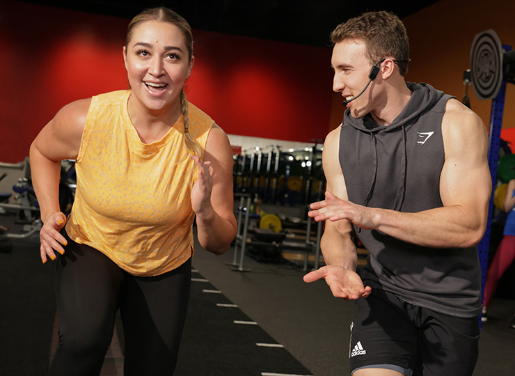 gym-goer working out with personal trainer