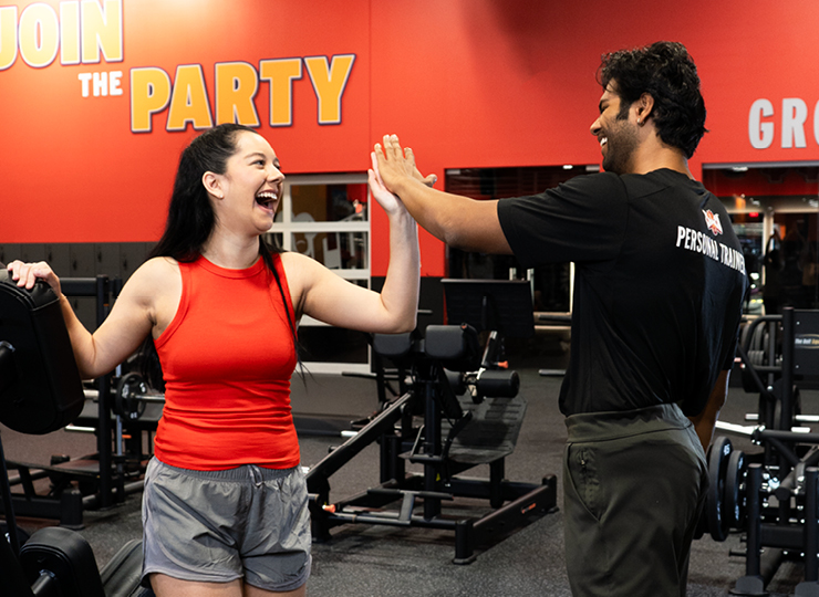 a woman high fiving her personal trainer at crunch fitness