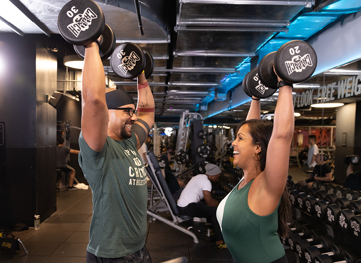 people smiling while lifting weights
