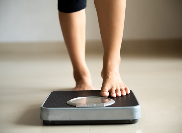 person weighing themselves
