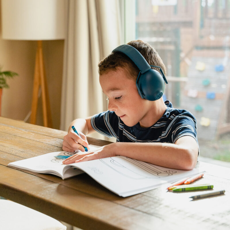 kid with headphones on coloring