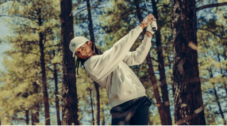man golfing in hat